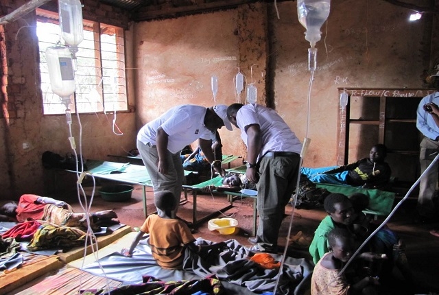 WHO Representative for Tanzania with the medical doctor in charge reviewing a severely dehydrated patient at the CTC at Nyarugusu