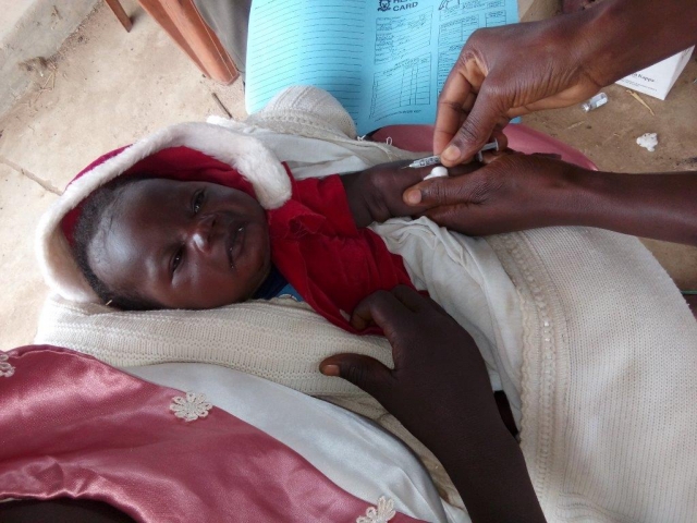 03 - A child being vaccinated against measles in Laniya