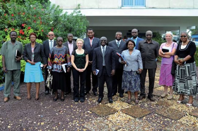 Photo des participants à la réunion d’évaluation à mi-parcours OMS-USAID devant la salle de conférence de l’OMS