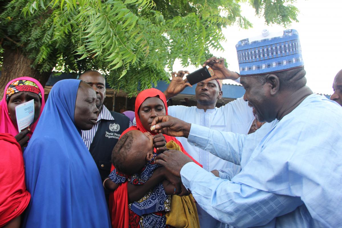 Head of Service,  vaccinating a child with oral cholera vaccine at Muna IDPs camp in Borno state.