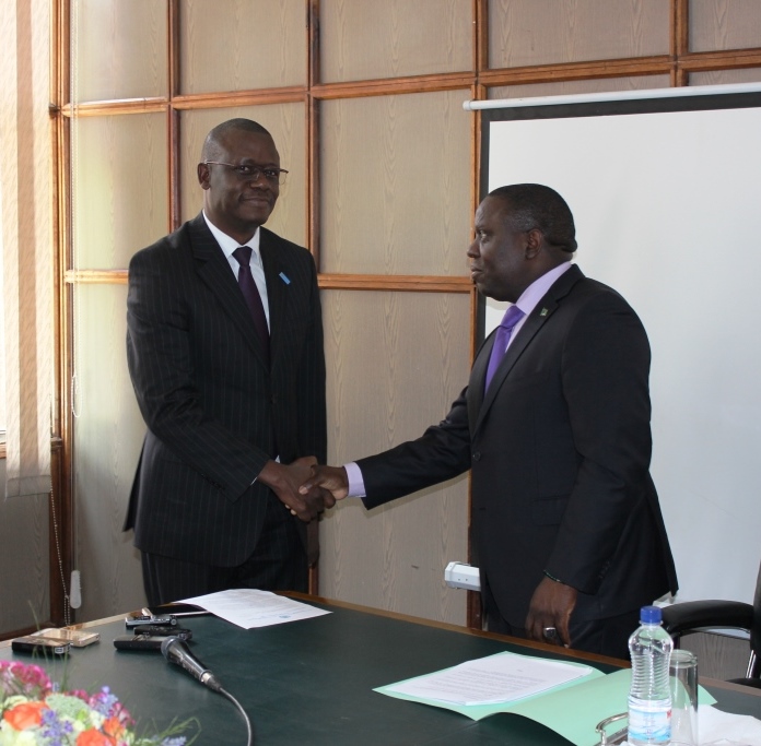 The WHO Representative, Dr. Nathan Nsubuga Bakyaita (left) shaking hands with the Minister of Forein Affairs Hon. Harry Kalaba after presenting letters of credence.