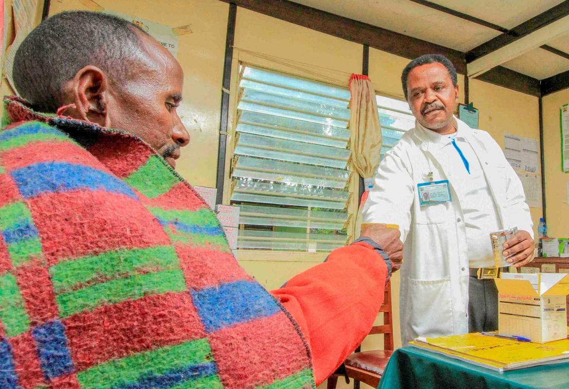 A health worker gives medication to a patient.  Kenya has embarked on a extensive evidence-based approach to root out TB 