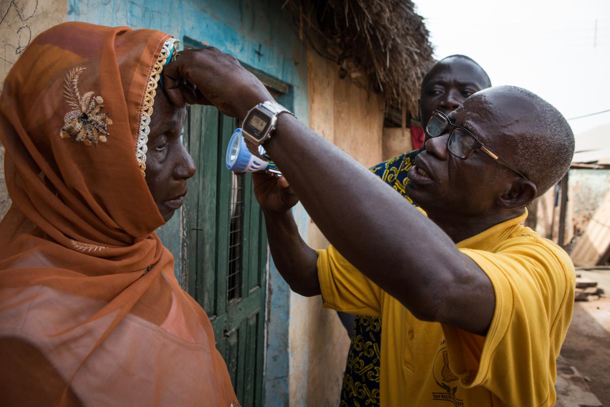 Opthalmic Nurse examining a woman in Yendi