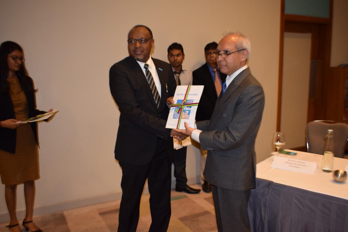 Dr Hon. Anwar Husnoo, Health Minister handing over a copy of the NHA 2017 Report to Dr Laurent Musango, WHO Representative in Mauritius