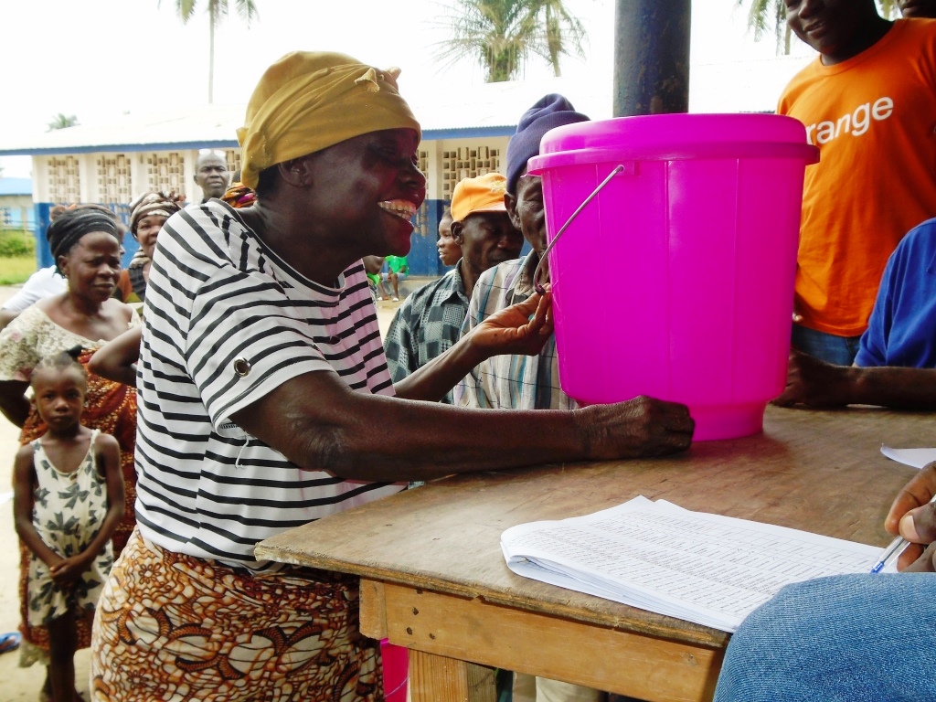 A flood affected victim thankfully receives supplies provided through the one UN support in Dolo's Town, Margibi County