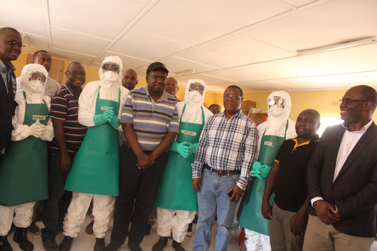 The Hon. Minister of Health, Dr. Chitalu Chilufya, (Centre) with the WHO Representative, Dr. Nathan Bakyaita (far left) with one of the RRTs in Solwezi