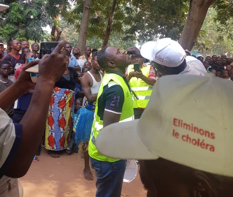 A local official receives a dose of oral cholera vaccine in Tshilenge, July 2019