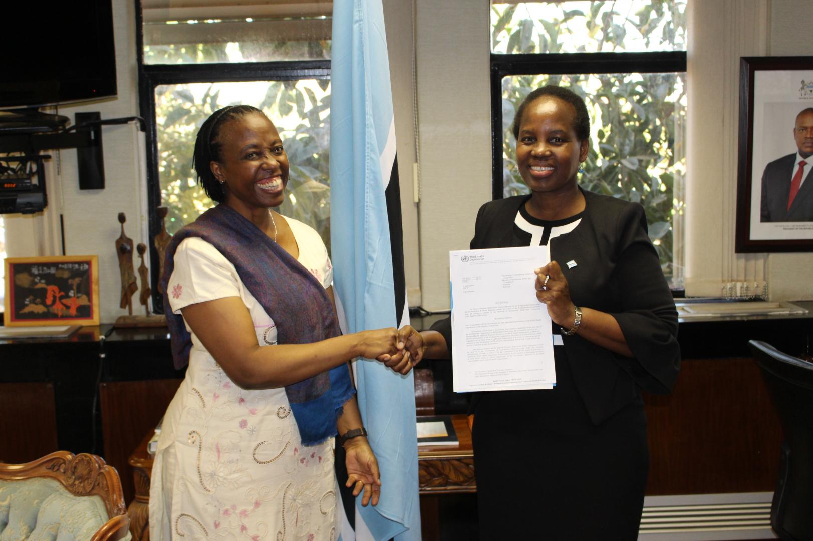 The Honourable Minister of International Affairs and Cooperation, Dr Unity Dow (right), receiving the credentials of the WHO Representative to Botswana, Dr Josephine Namboze (left)