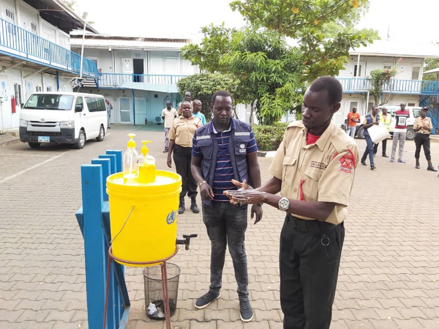 Security guards deployed at WHO office in Juba,  practices hand washing as a recommended measure to prevent the spread of #COVID-19