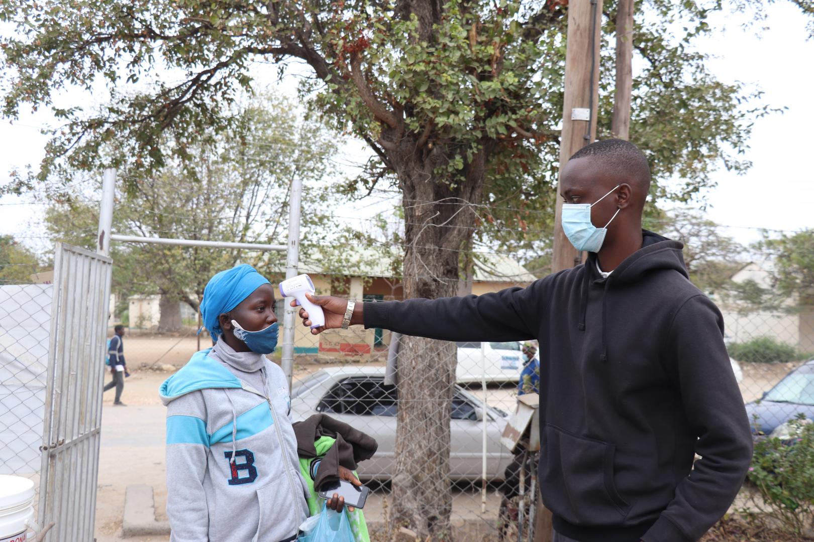 Mmoloki Malemane (right) checking a patient’s temperature before they enter the hospital as part of his Covid-19 pre-screening routine.