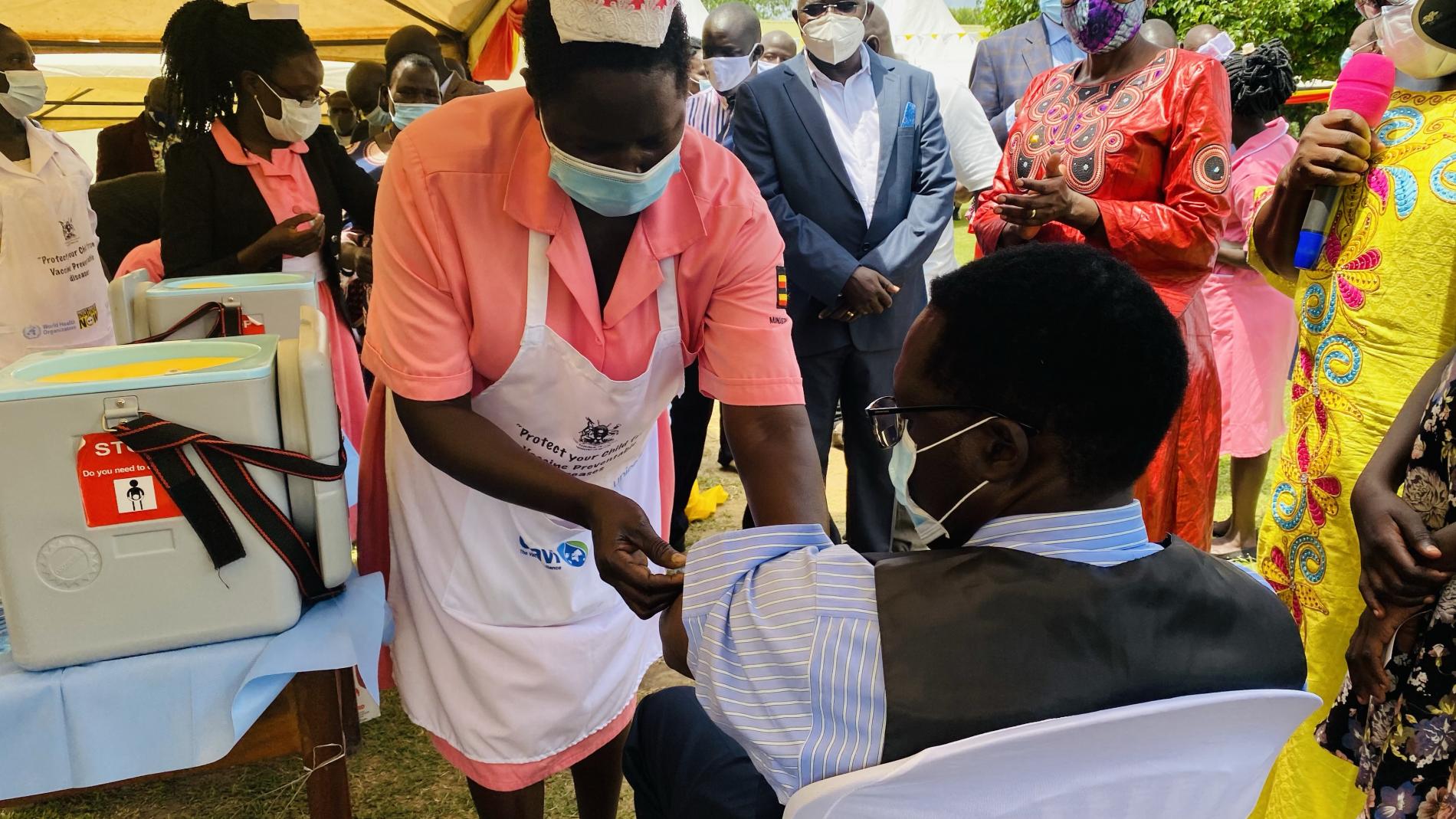 Health worker vaccinates a resident of Moyo District against Yellow Fever