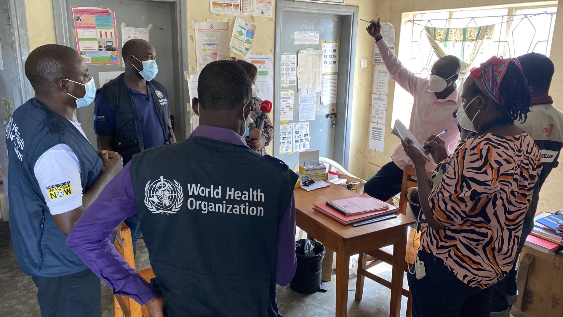 WHO officials talk to the health workers at Kasensero Health Center II