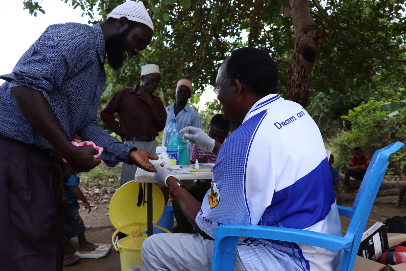 A project assistant collecting blood sample for testing 