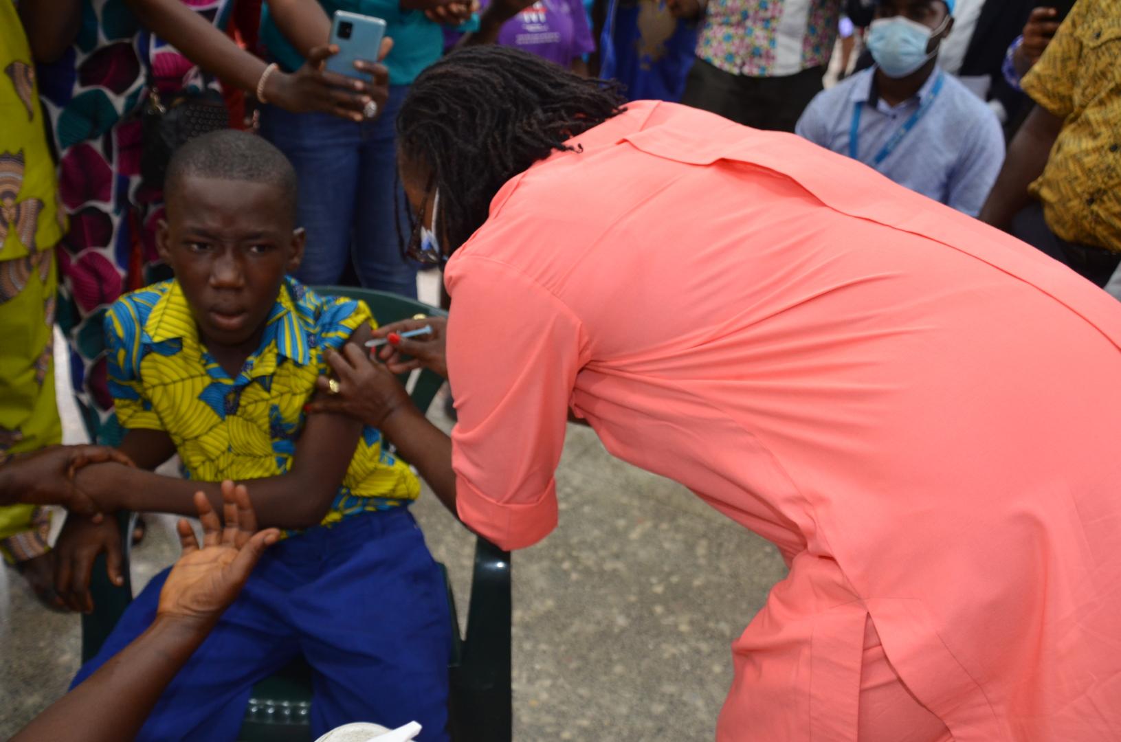 Health Minister, Dr. Jallah vaccinating first child during the TCV launch in Monrovia