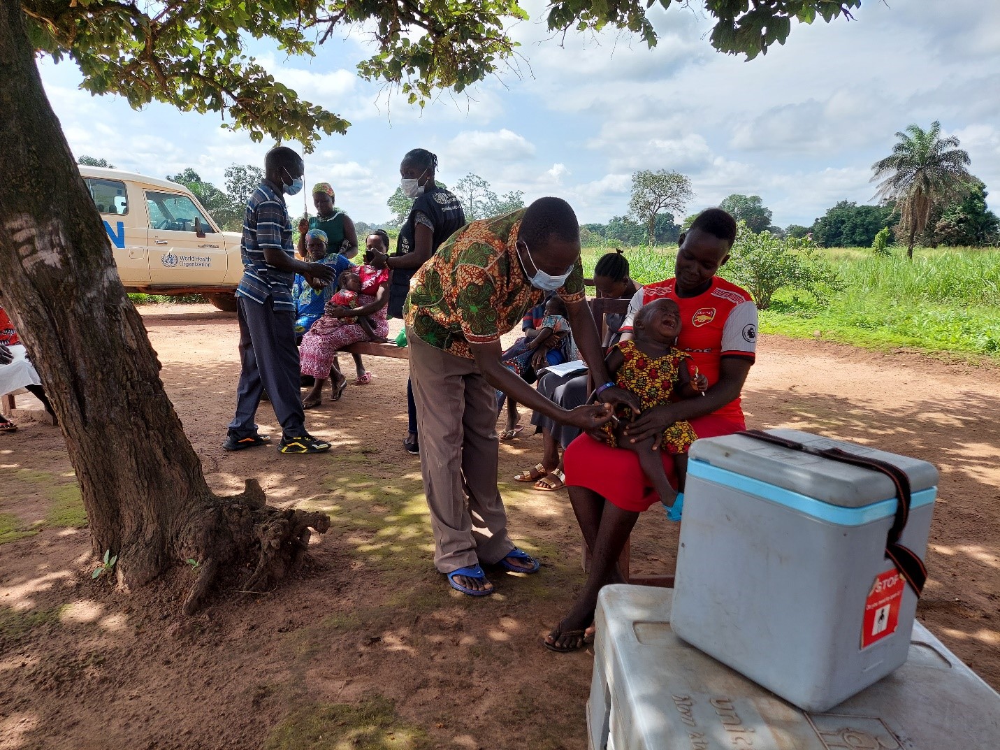 Children receiving vaccines under a tree in the hard-to-reach Nadiangere village in South Sudan