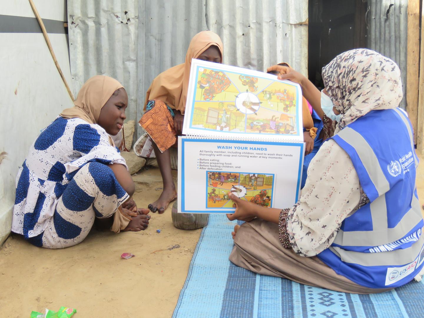 A member of the community health champion providing interpersonal risk communication messages on Cholera, Covid-19, Measles, Malaria among other to some women in IDPs camp. Photo-credit: Kingsley/WHO 