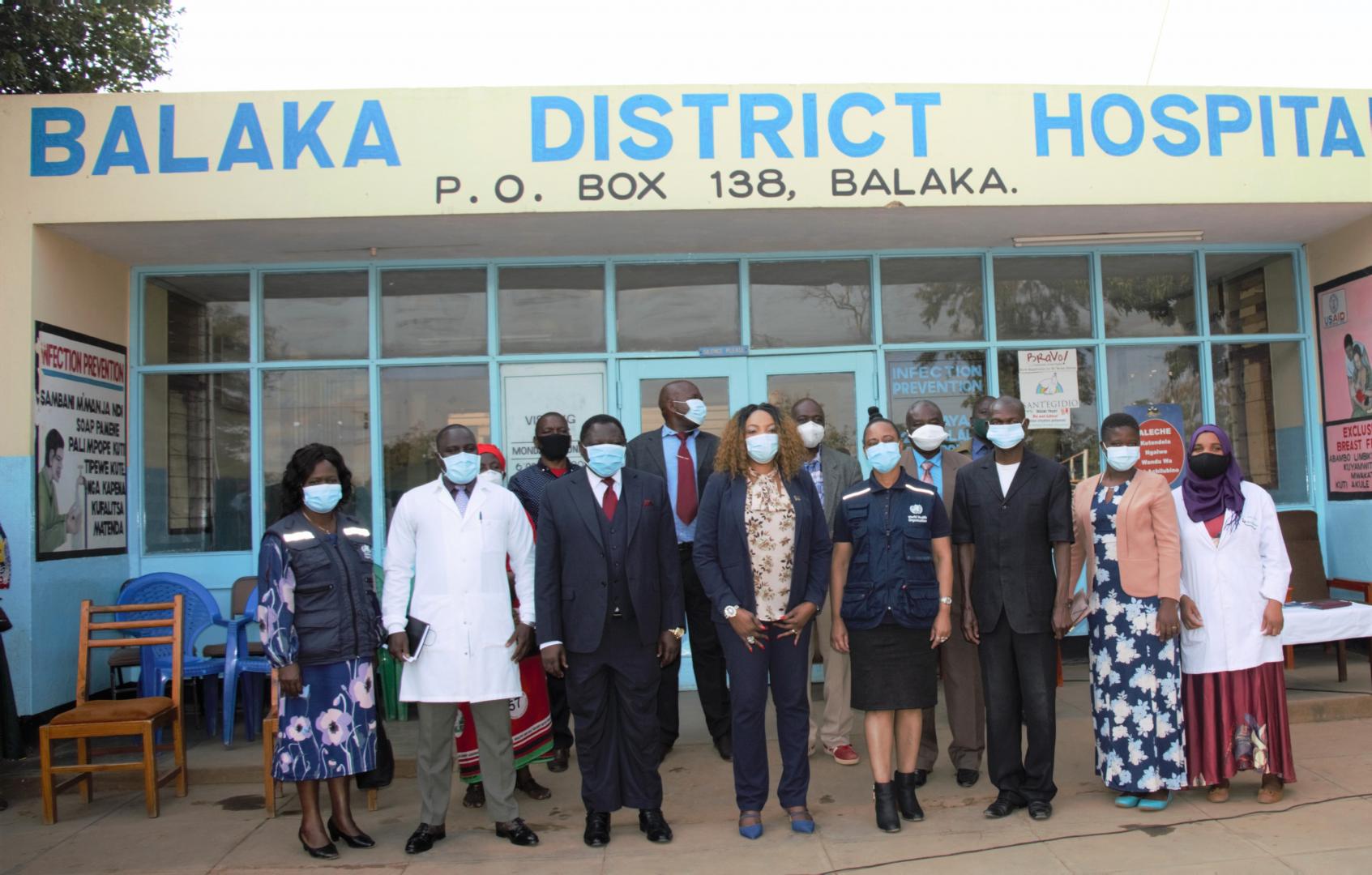 The Honorable Minister and the WHO Representative, 4th and 5th from left in front of Balaka District Hospital