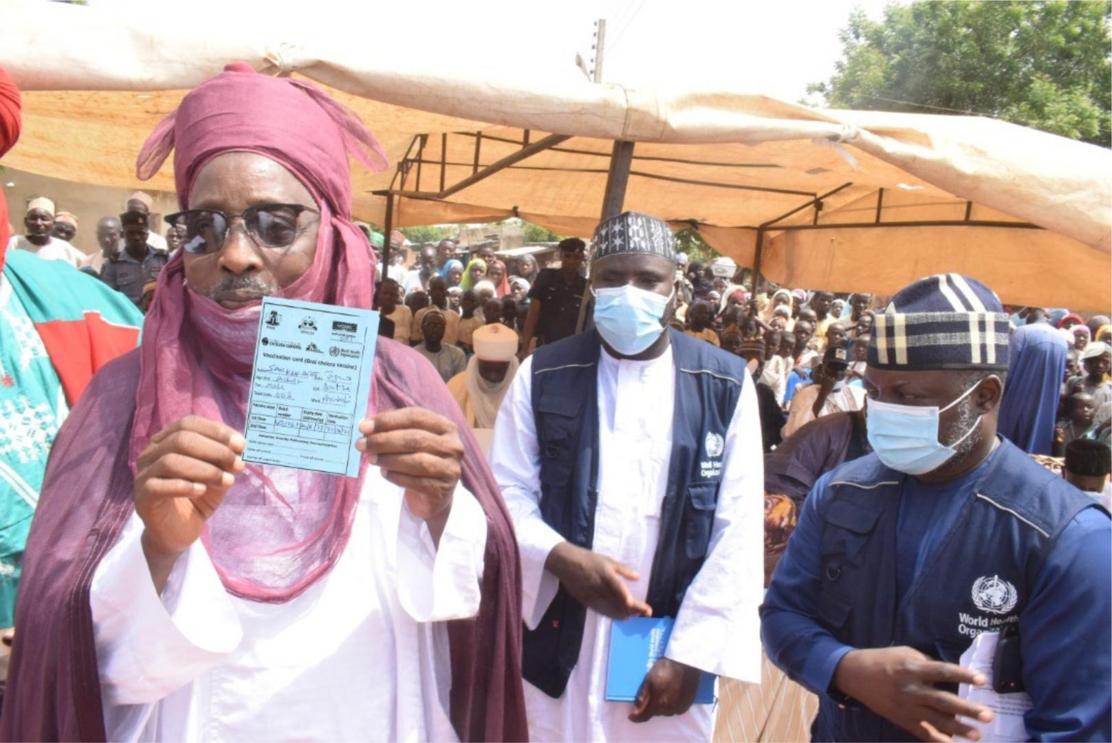 The Emir of Duste, His Royal Highness Dr Nuhu Muhammadu Sanusi showing off his vaccination card after receiving OCV during the flag-off