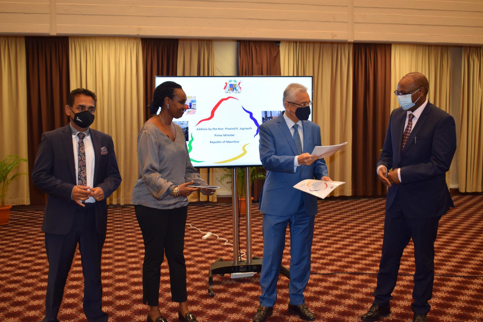 Hon. Prime Minister of Mauritius, P.K. Jugnauth handing over a copy of the national survey report on people who use drugs to the WHO Representative, Dr L. Musango in the presence of UNRC,  H. E. Mrs C. Umutoni and the Coordinator, National Drug Secretariat, Dr S. Appadoo