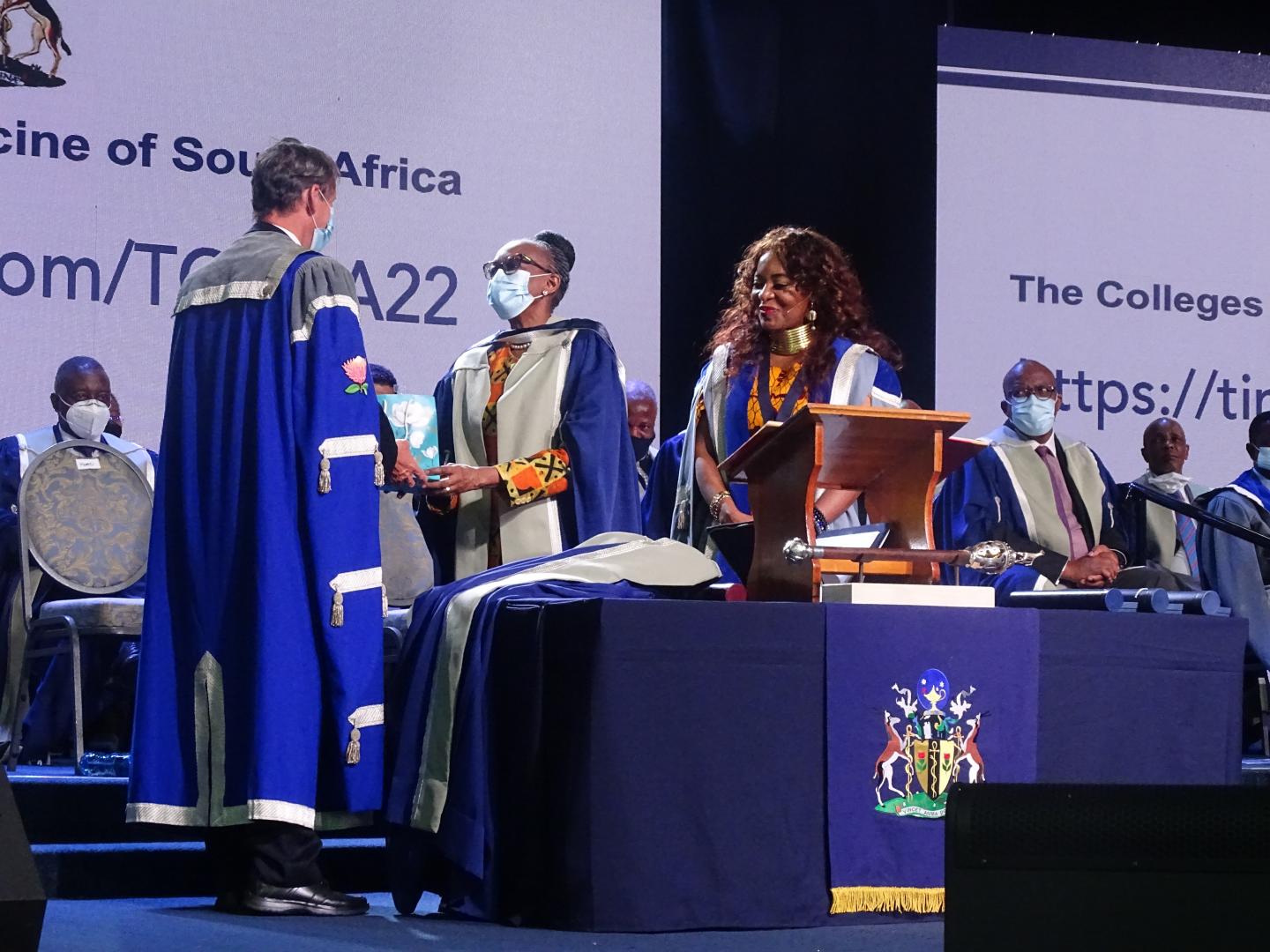 Professor Fagan (left) is presenting a memorable gift from the CMSA to Dr Matshidiso Moeti. 