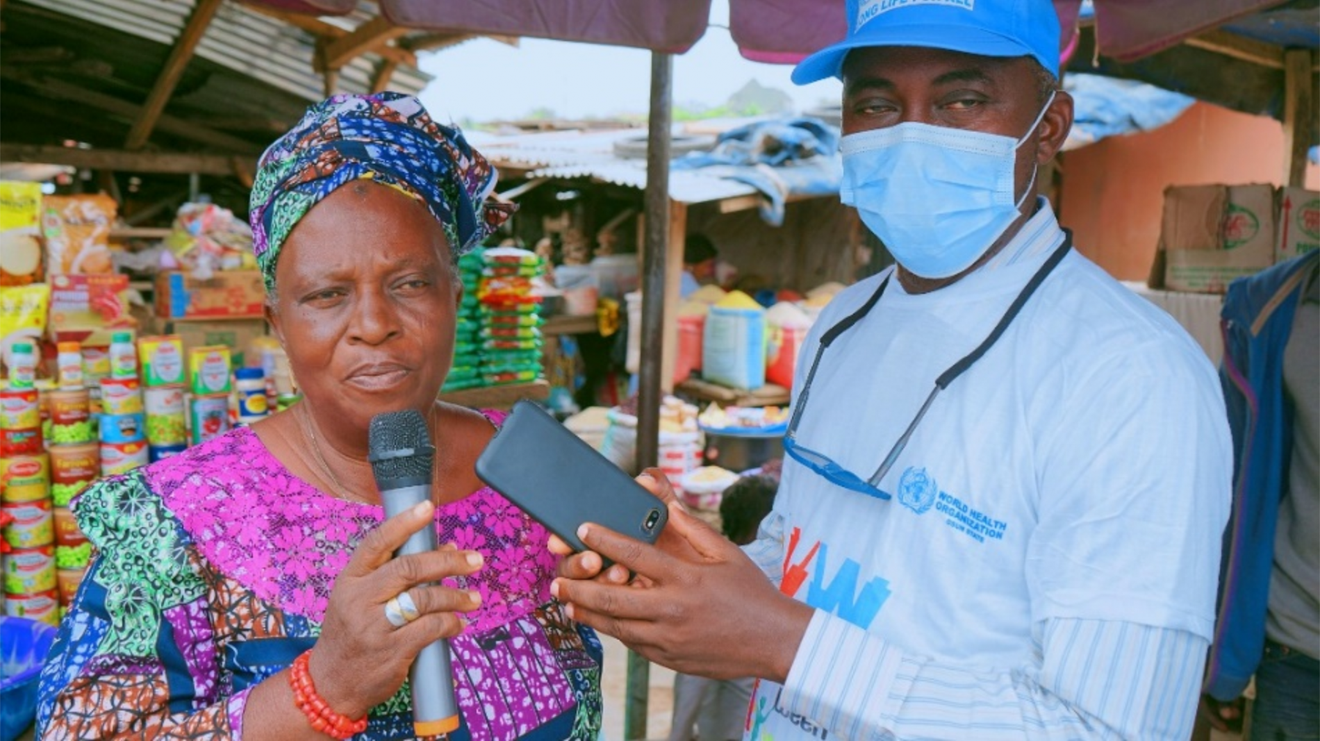 The head of Akindeko market (left) speaking on the importance of vaccination.png