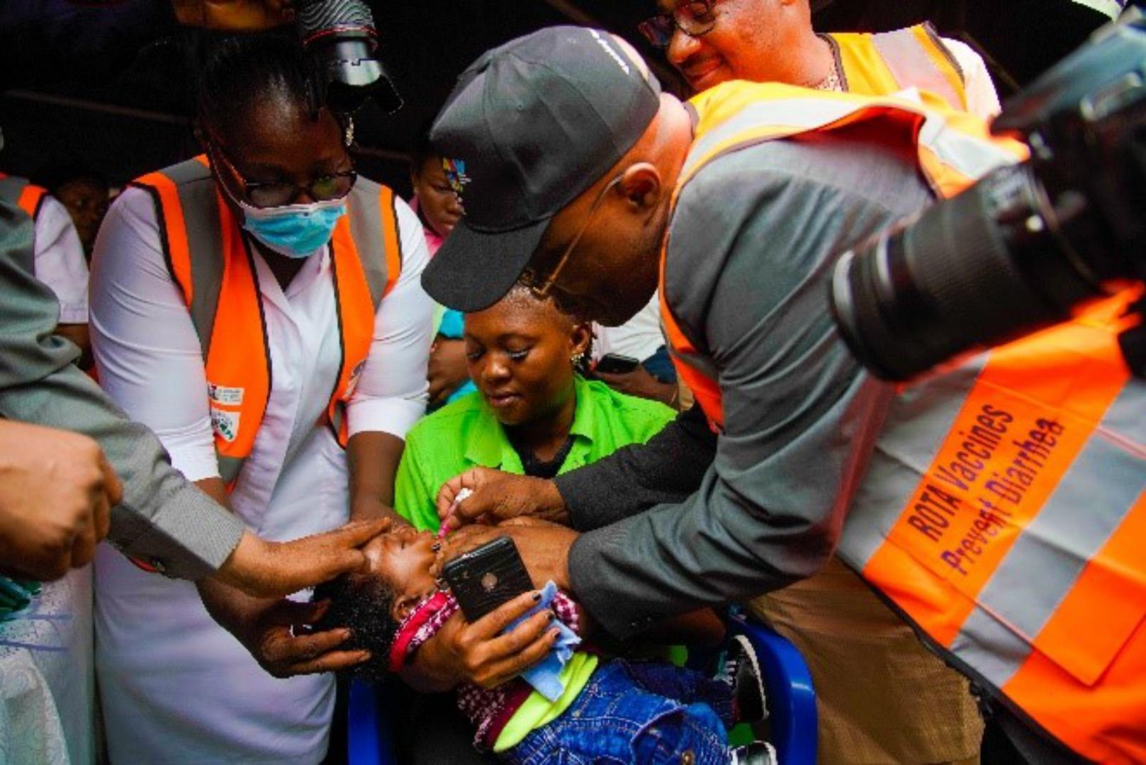 The WHO Country Representative administering a dose of Rotavirus Vaccine