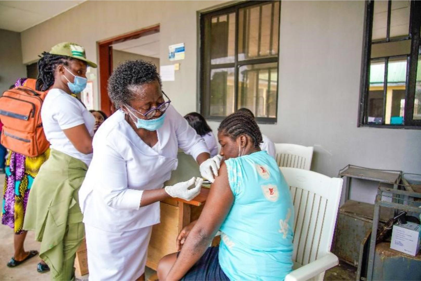 A mother recieving the first dose of COVID-19 vaccine_