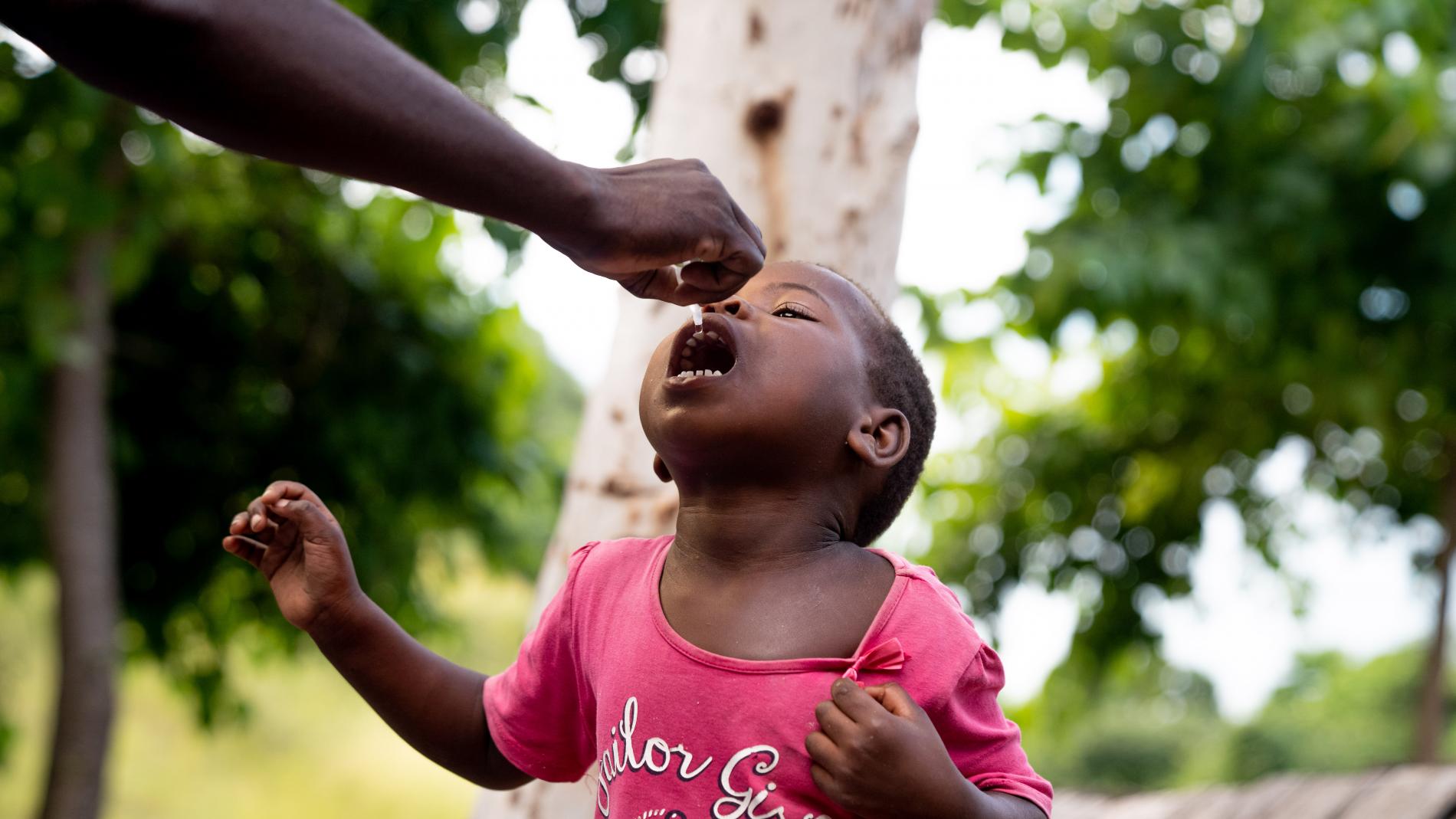 A child receiving a dose of Oral Polio Vaccine