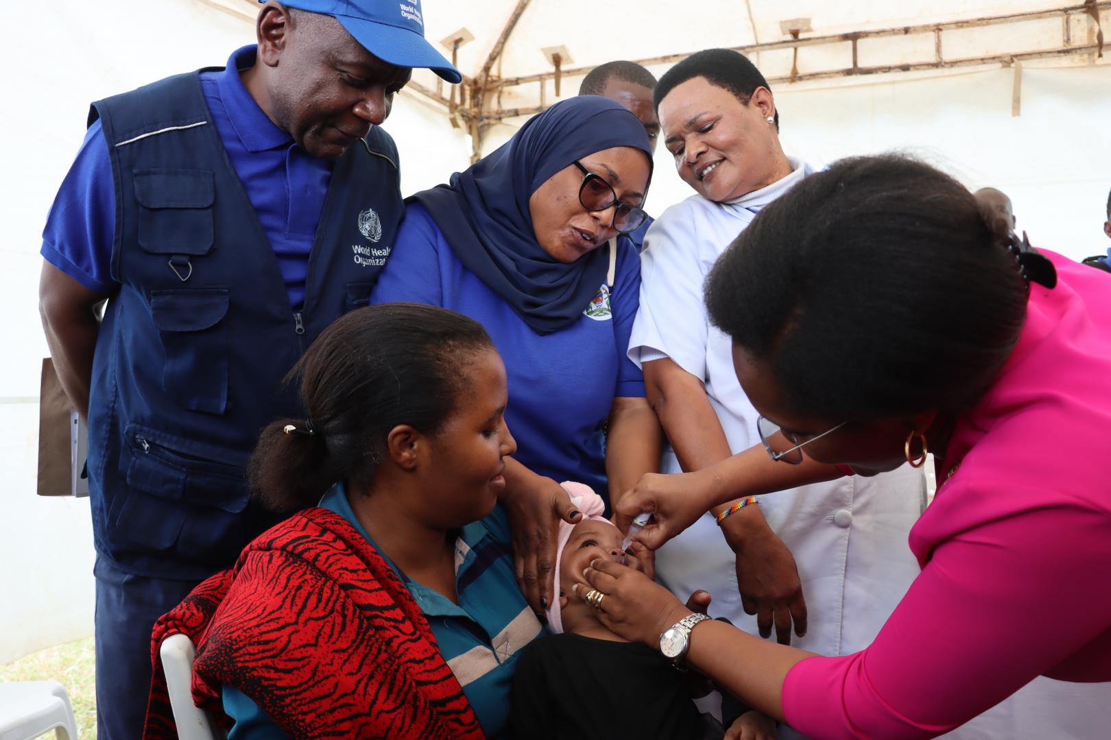 Professor Tumaini Nagu, Chief Medical Officer giving a dose of measles vaccination 