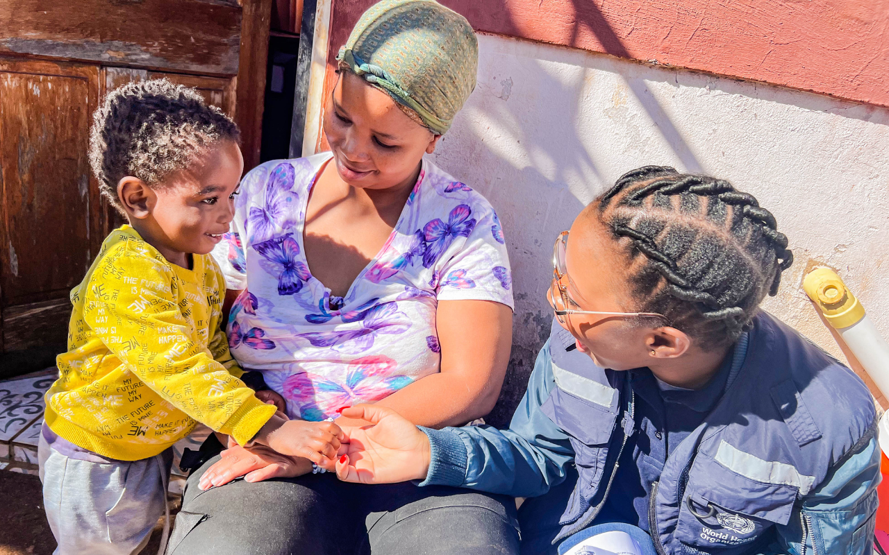 WHO South Africa staff member with Tebogo and her son during a home visit at the onset of the cholera outbreak