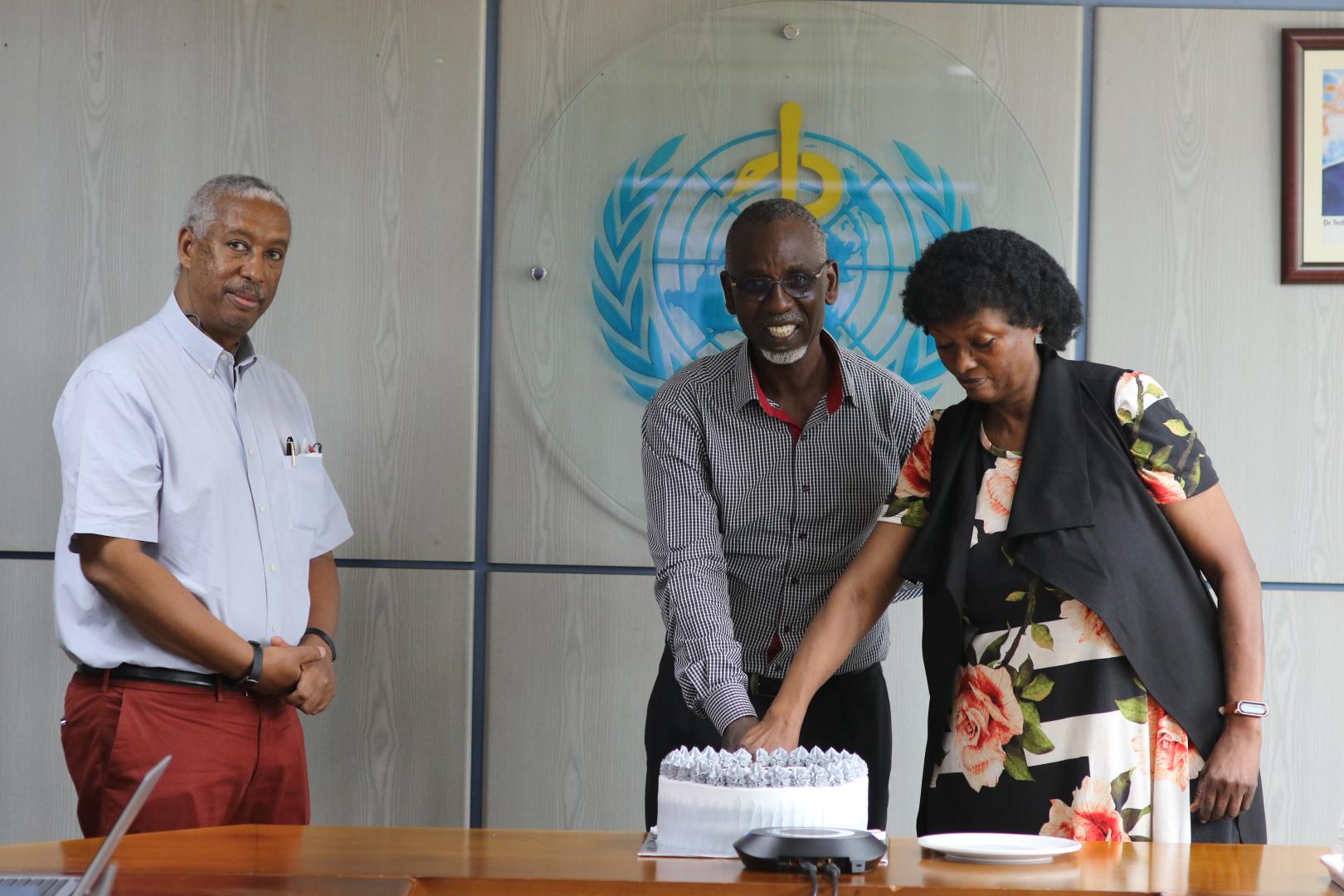 Dr. Yonas Tegegn, WHO Representative to Uganda (far left) at the service end of Mrs. Elizabeth Malinga, and Mr. Collins Mwesigye, WHO Climate Change Officer.