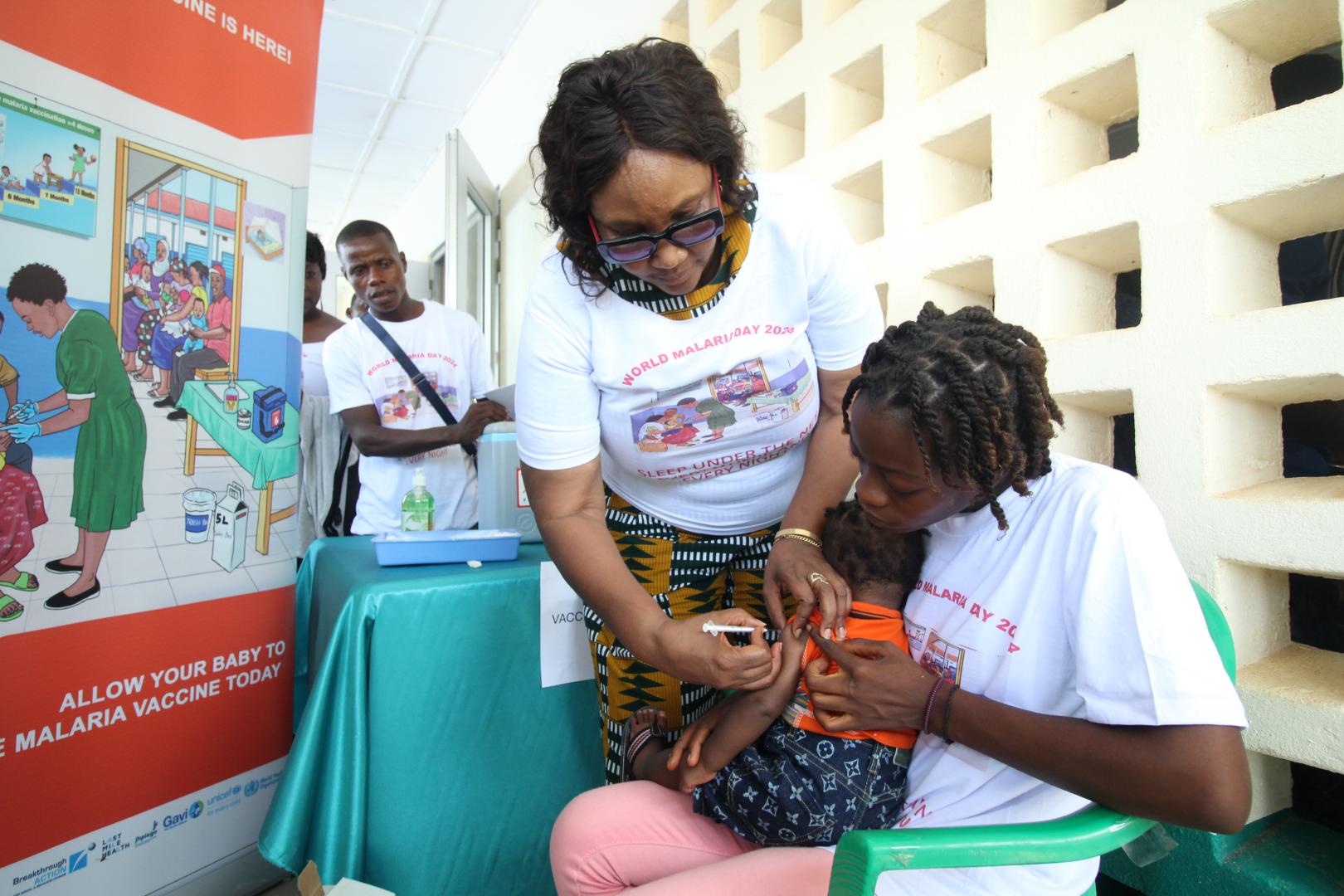 Health Minister Dr. Louise Kpoto administers the first dose Malaria Vaccine during the launch of Malaria Vaccine in Liberia