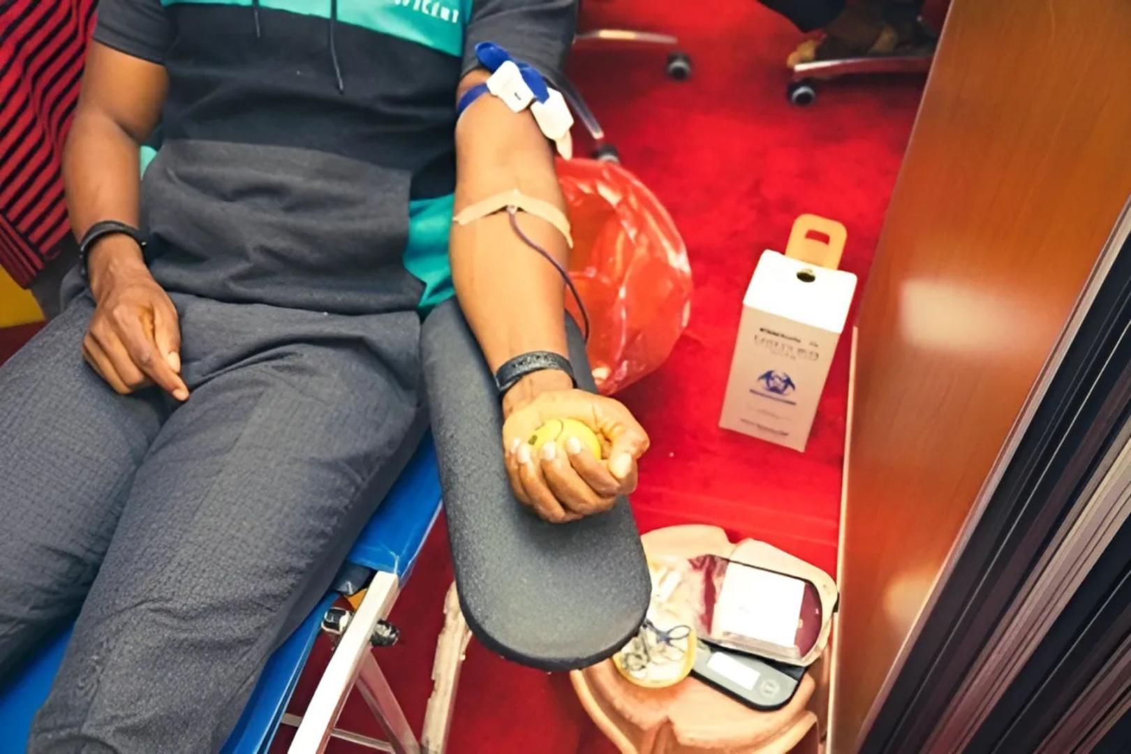 A donor donating blood during the UN blood drive to mark World Blood Donor Day
