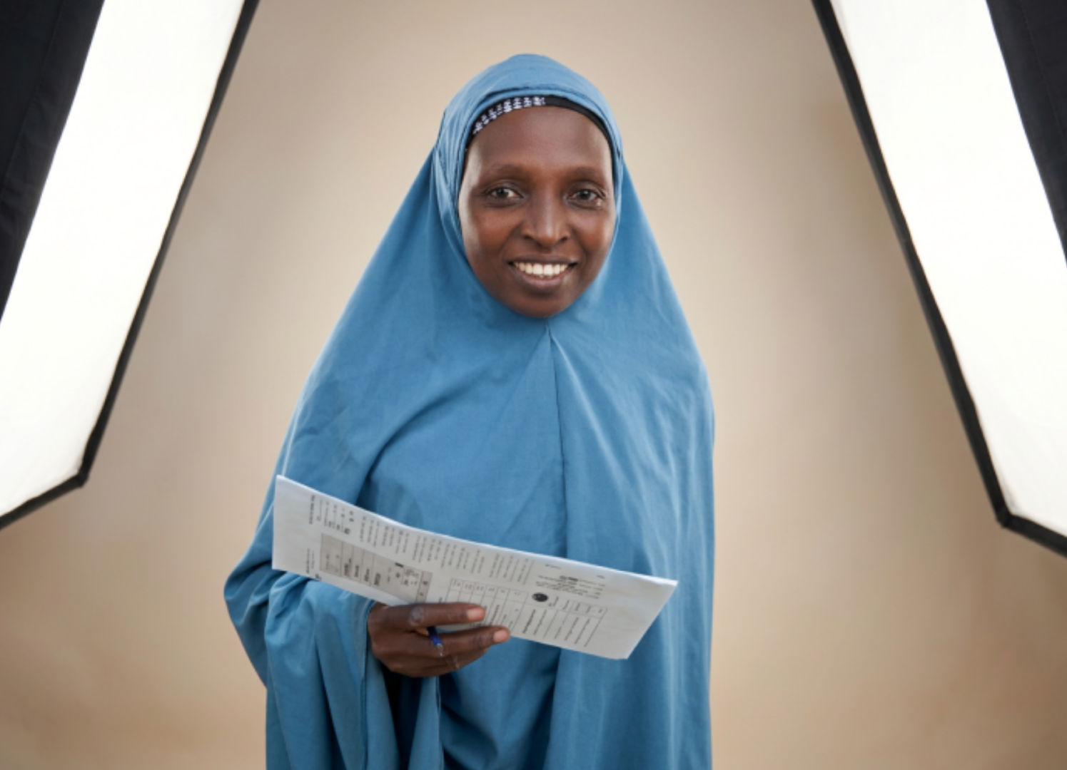 Amina displaying the childs vaccination card