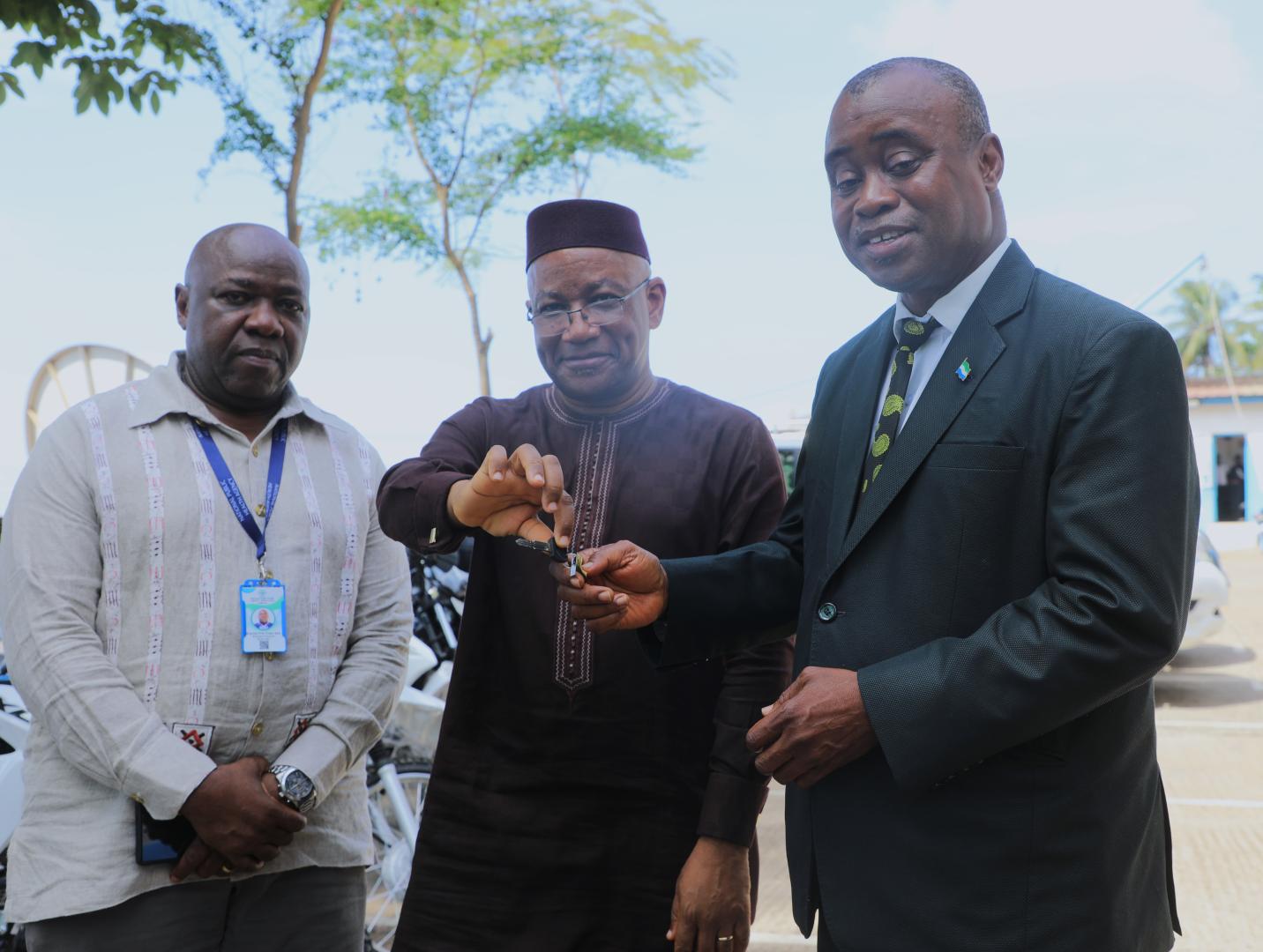 WHO Country Representative handing over motorbike keys to the Deputy Minister of Health