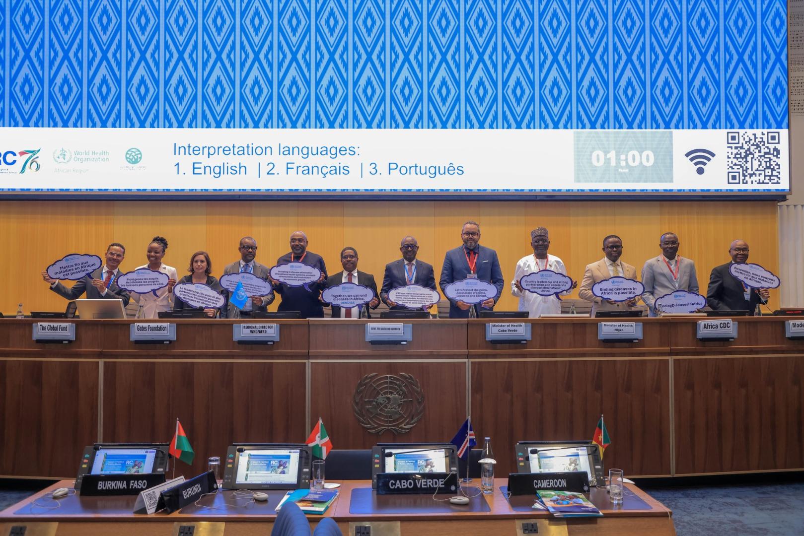 Health ministers and partners hold signs reading “Ending diseases in Africa is possible” at the Seventy-sixth session of the WHO Regional Committee for Africa