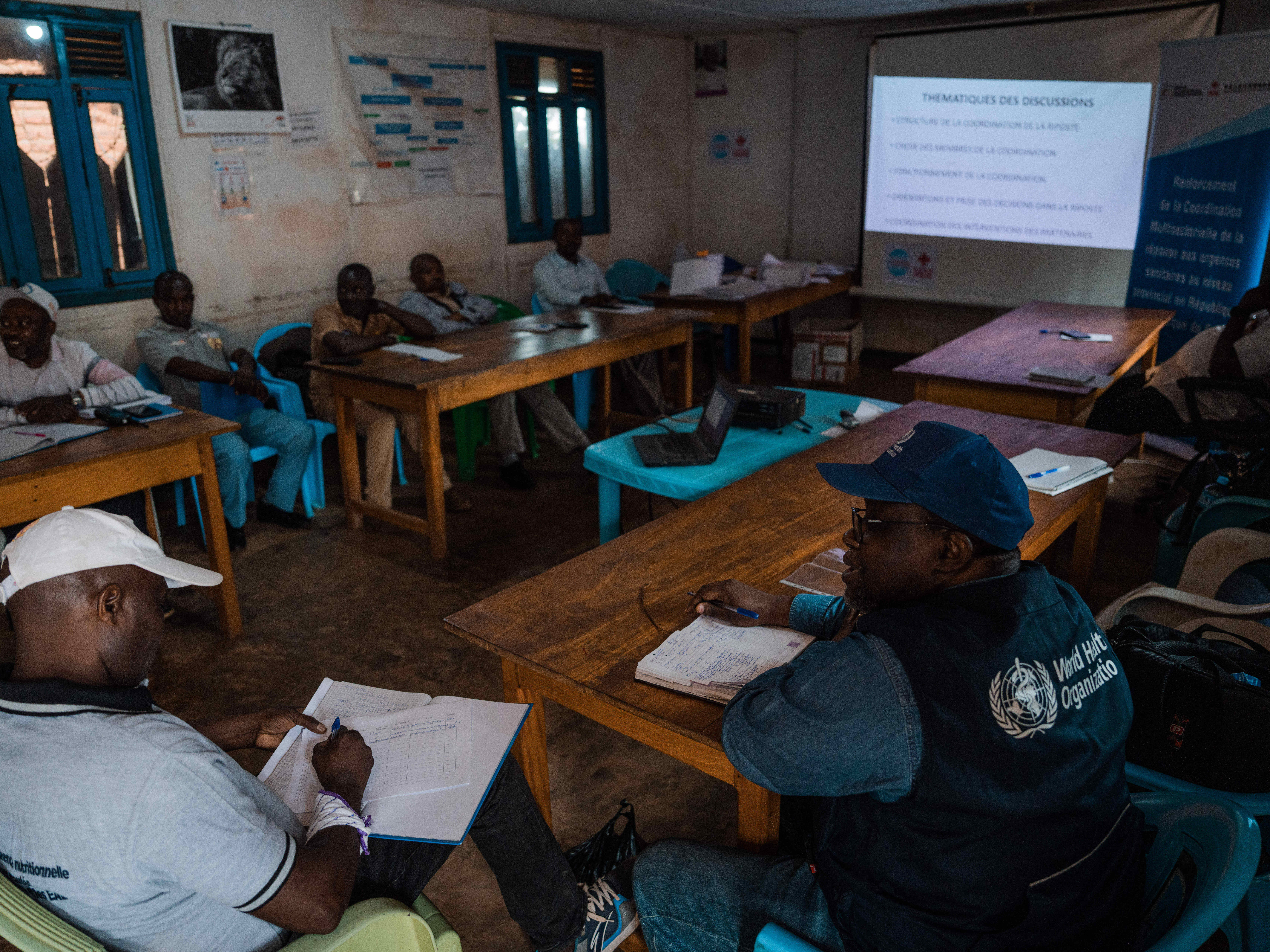 Les membres des différentes commission mises en place pour la riposte contre Ebola posent dans l’enceinte du Bureau central de la zone de santé (BCZ) de Beni, en présence de l’équipe de l’OMS. Les épidémies majeures qui ont touché la région ont souvent été cordonnées à partir de ce BCZ. OMS/Hugh Cunningham Kinsella  