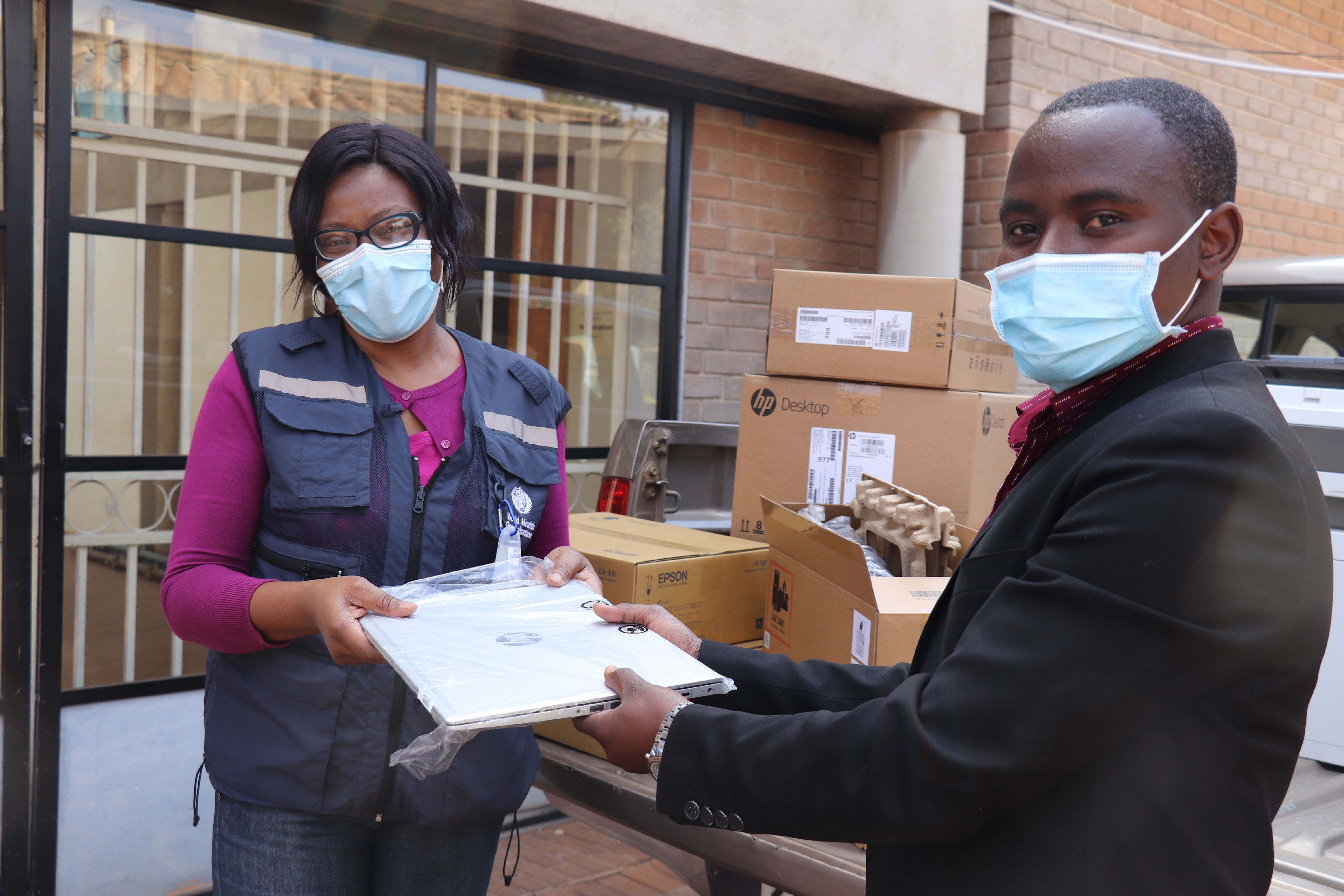 Louis Mukumba receiving office equipment on behalf of City of Harare 