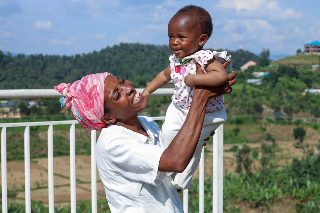 Umutoniwase Marie Claire playing with her daughter Ornella