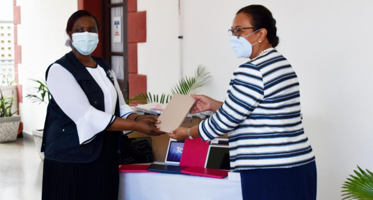 The Minister of Health Honourable Peggy Vidot accepting the donations of tablet from the WRai Dr. Susan Tembo.