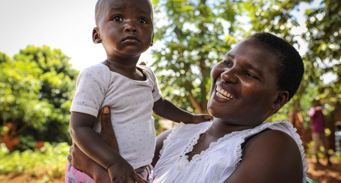 A happy mother near Lilongwe smiles relieved after getting her child vaccinated against polio