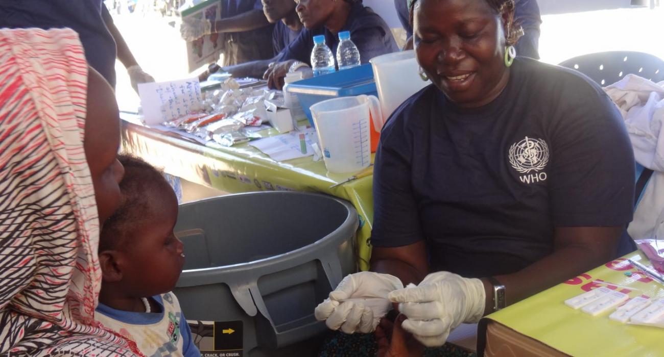 A woman is tested for malaria as part of activities to mark the UN Day