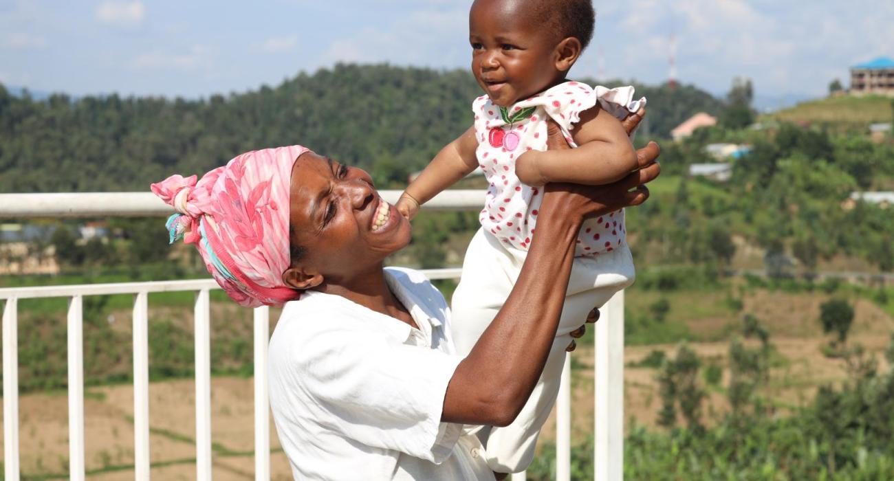 Umutoniwase Marie-Claire playing with her daughter Ornella