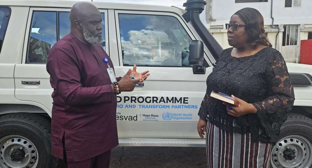 WHO Representative Dr Olu Olushayo handing over the vehicle to Dr Catherine Cooper, Chief Medical Officer at Ministry of Health