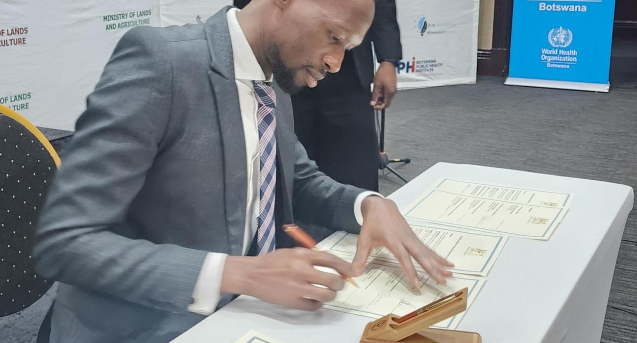 Honorable Acting Minister of Health, Mr Lawrence Ookeditse, signing the commitment for the implementation of the One Health National Strategy