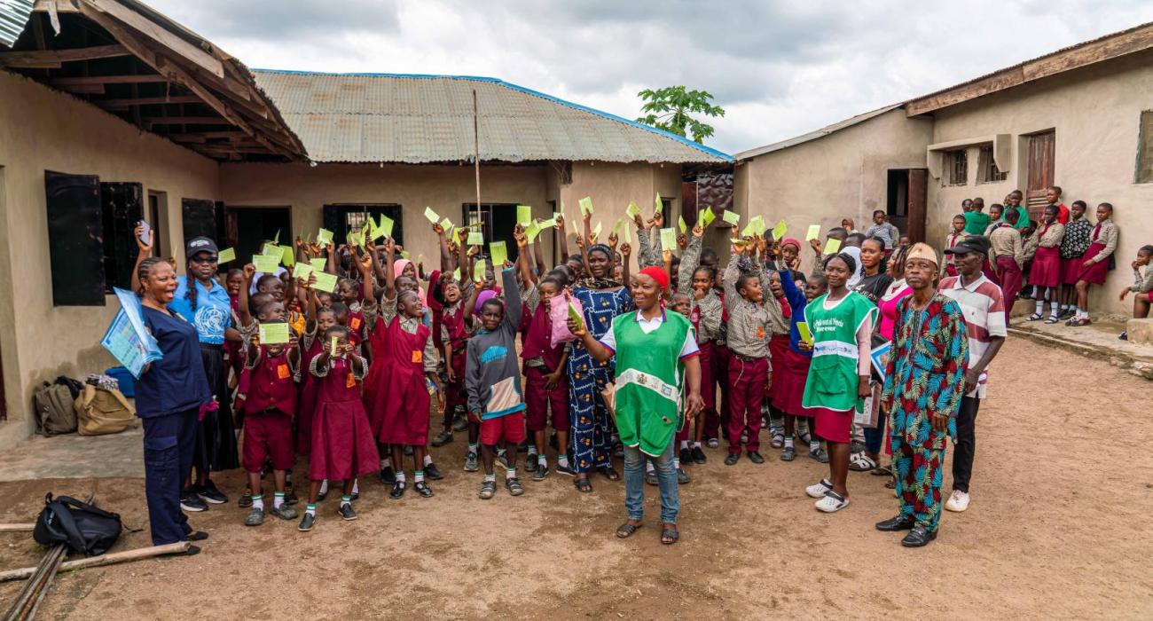 MR campaign; children displayimg their vaccination cards