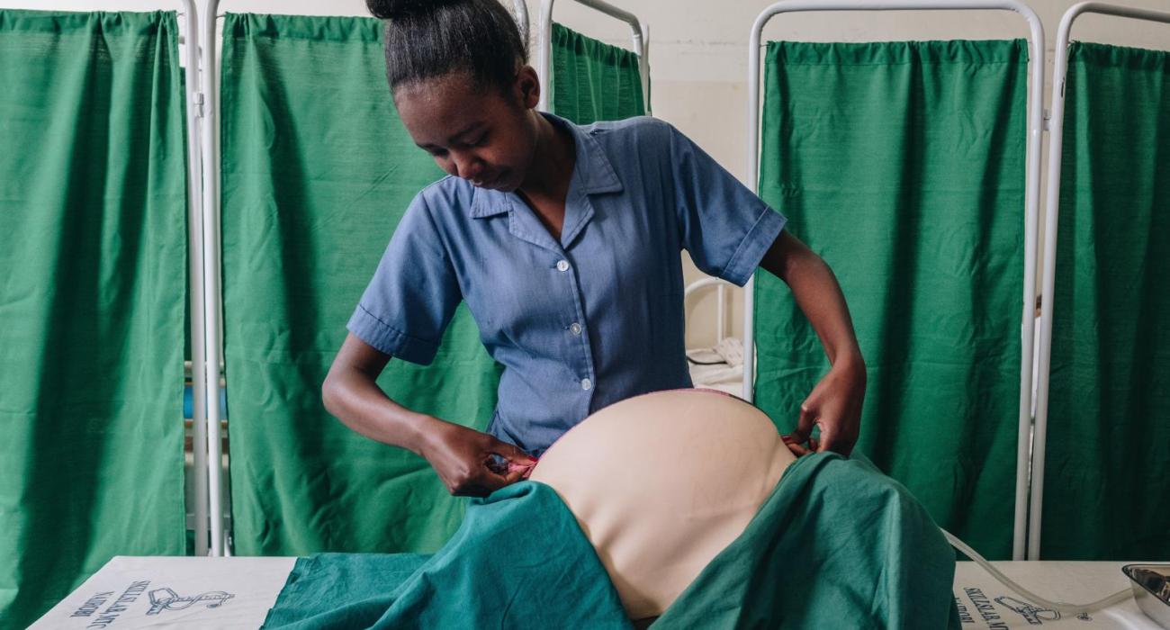 Student Diana Ribia demonstrates how to assess whether a baby is growing normally by measuring the height of the top of the mother’s uterus at the Kenya Medical Training College Skills Lab, Nairobi.