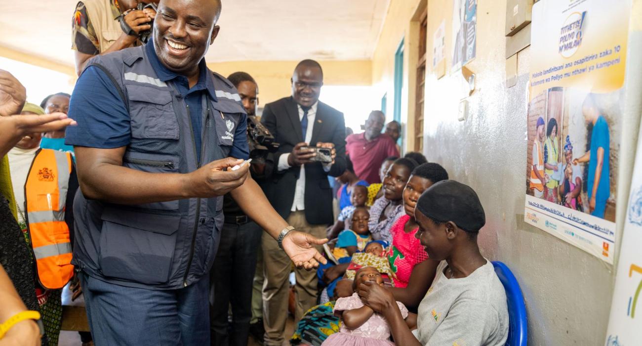 WHO Malawi Rep Dr Charles Njuguna vaccinates a child against polio at Kabudula Community Hospital