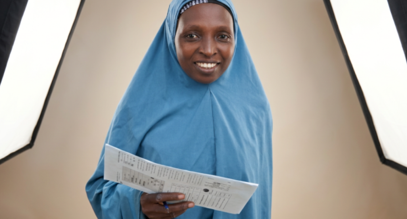 Amina displaying the childs vaccination card