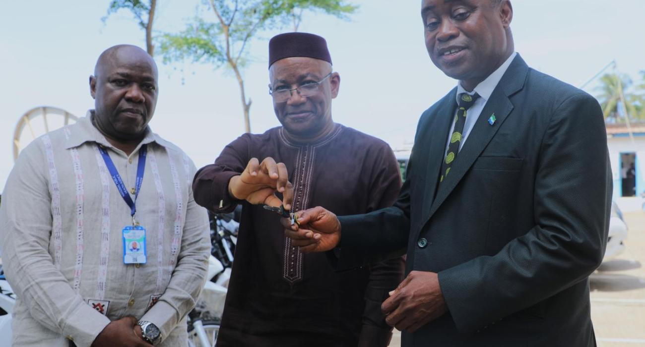 WHO Country Representative handing over motorbike keys to the Deputy Minister of Health